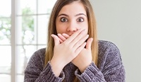 Woman covering her mouth with both hands
