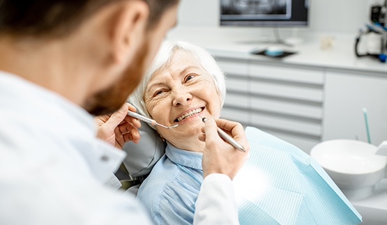Senior woman receiving dental checkup