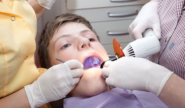 Child receiving a dental treatment