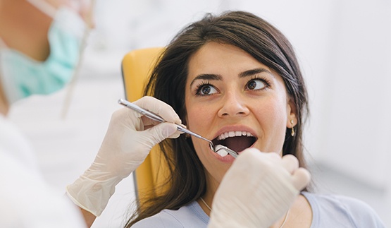 Woman undergoing a tooth extraction