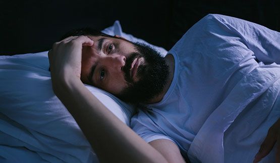 Man laying awake in bed