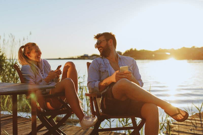 Couple smiles by lake