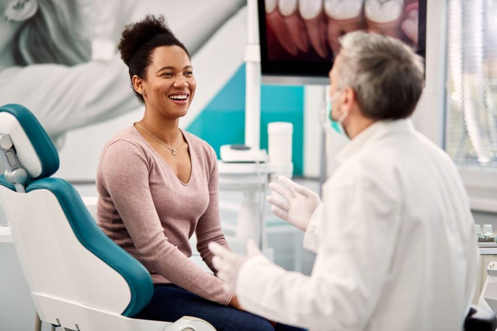 A woman discussing her oral health with her dentist.